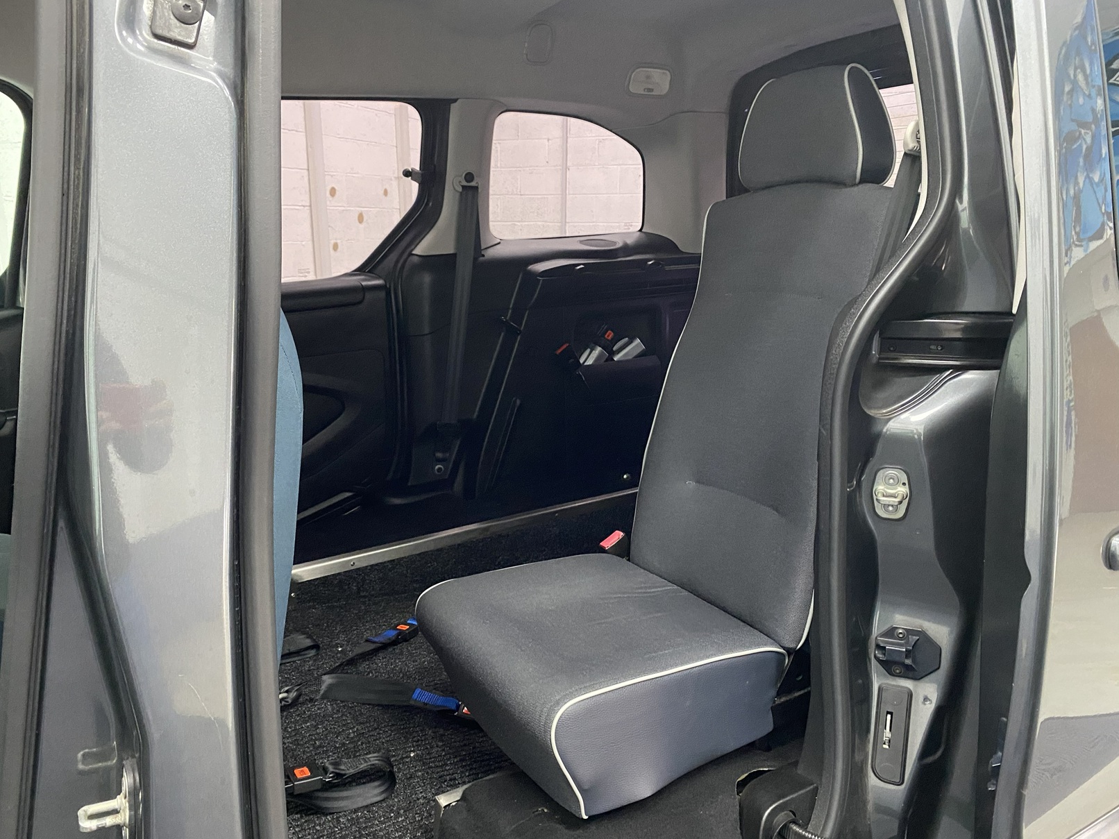 The rear single seat of a wheelchair accessible Citroen Berlingo Nk68 AYF 17