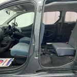 The side view of a Wheelchair accessible Citroen Berlingo with the front doors open showing the interior Nk68 AYF