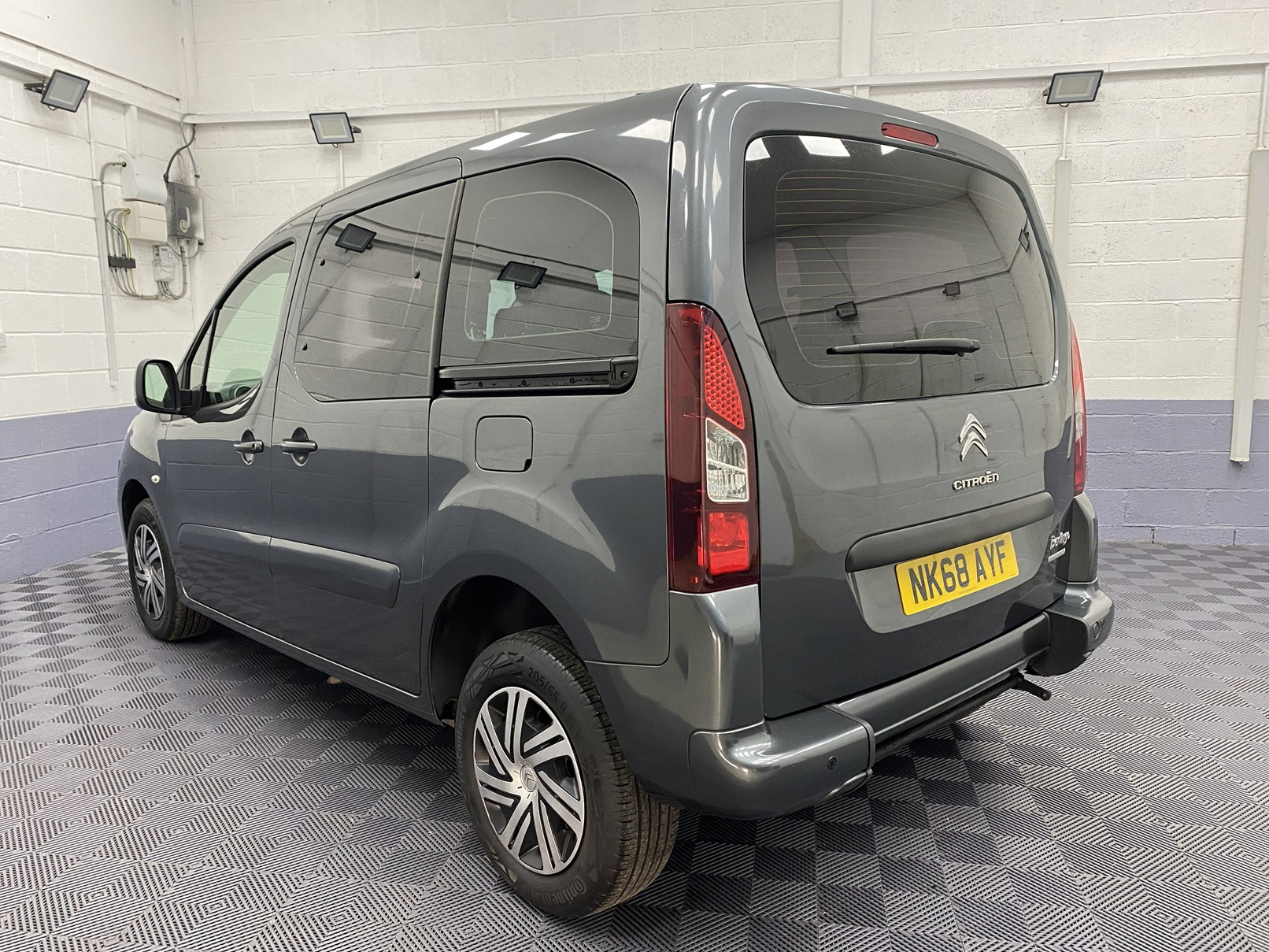 A Grey wheelchair accessible accessible (WAV) Citroen Berlingo that is for sale at Michael Harraway Cars in Weston super Mare Rear side view. NK68 AYF 5