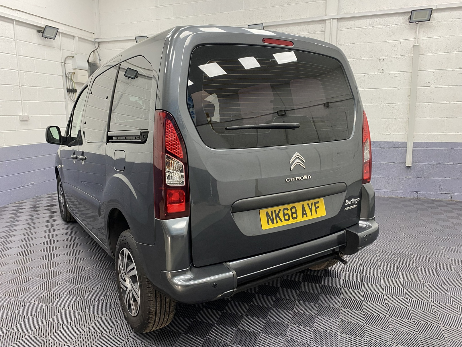 A Grey wheelchair accessible accessible (WAV) Citroen Berlingo that is for sale at Michael Harraway Cars in Weston super Mare Rear side view. NK68 AYF 6