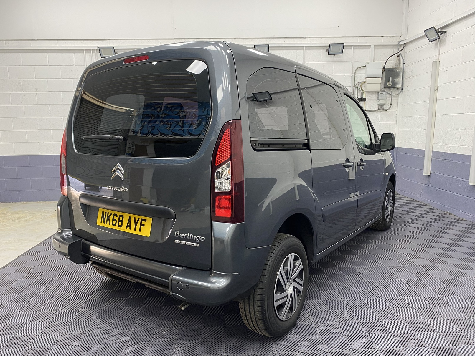 A Grey wheelchair accessible accessible (WAV) Citroen Berlingo that is for sale at Michael Harraway Cars in Weston super Mare Rear side view. NK68 AYF 8