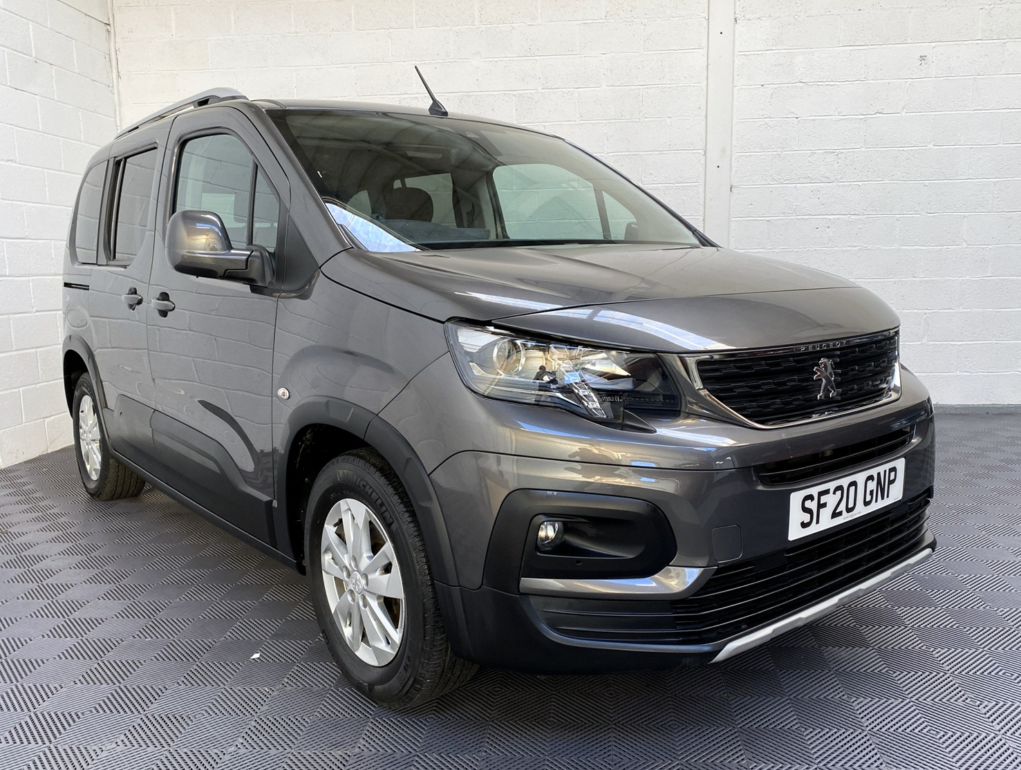 Peugeot Rifter WAV wheelchair accessible vehicle for sale at Michael Harraway Cars, Weston-super-Mare, with three passenger seats, space for one wheelchair user, and a lightweight fold-flat rear access ramp. SF20 GNP 1