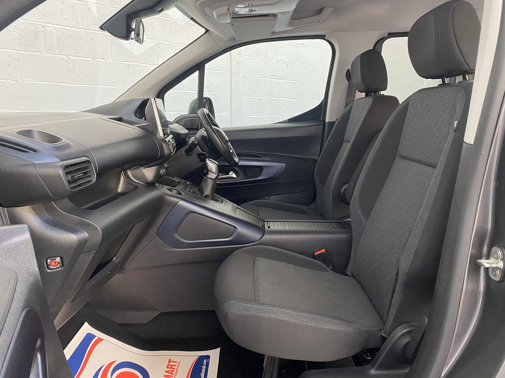 Peugeot Rifter WAV wheelchair accessible vehicle for sale at Michael Harraway Cars, Weston-super-Mare, with three passenger seats, space for one wheelchair user, and a lightweight fold-flat rear access ramp. SF20 GNP17