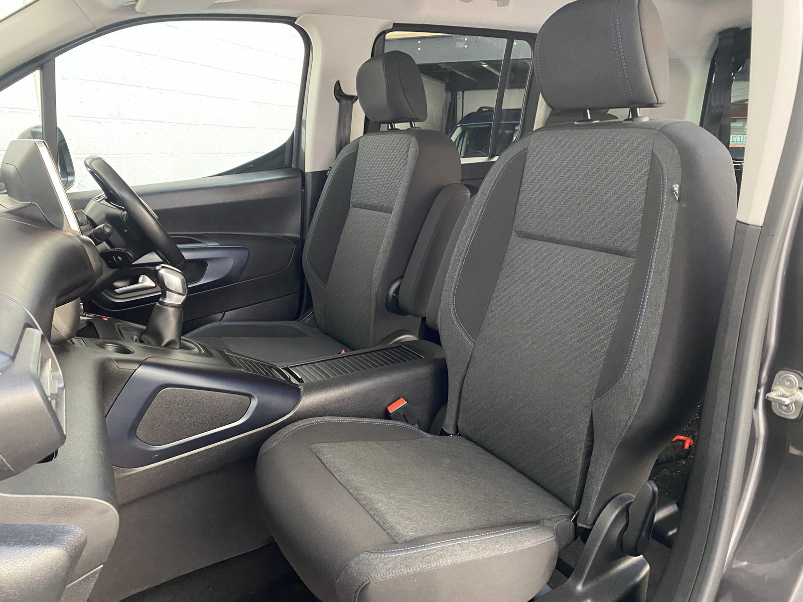 Peugeot Rifter WAV wheelchair accessible vehicle for sale at Michael Harraway Cars, Weston-super-Mare, with three passenger seats, space for one wheelchair user, and a lightweight fold-flat rear access ramp. SF20 GNP 18