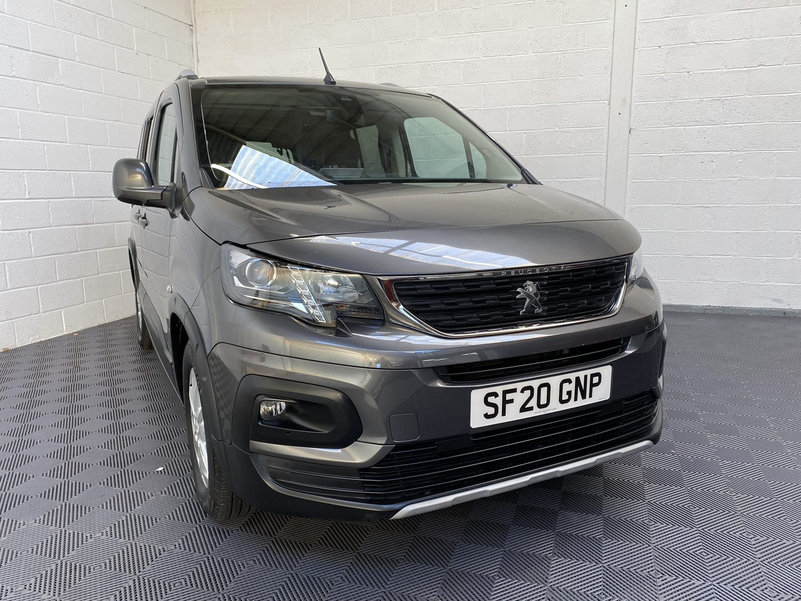 Peugeot Rifter WAV wheelchair accessible vehicle for sale at Michael Harraway Cars, Weston-super-Mare, with three passenger seats, space for one wheelchair user, and a lightweight fold-flat rear access ramp. SF20 GNP 2