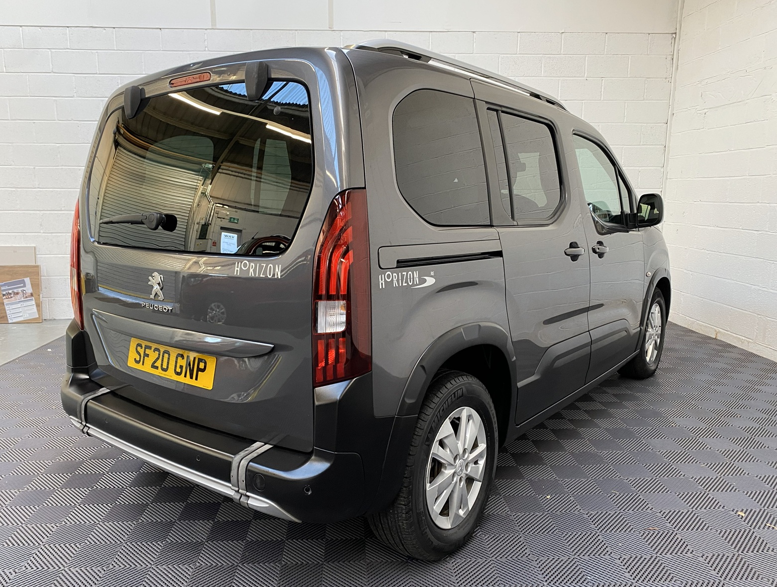Peugeot Rifter WAV wheelchair accessible vehicle for sale at Michael Harraway Cars, Weston-super-Mare, with three passenger seats, space for one wheelchair user, and a lightweight fold-flat rear access ramp. SF20 GNP 8