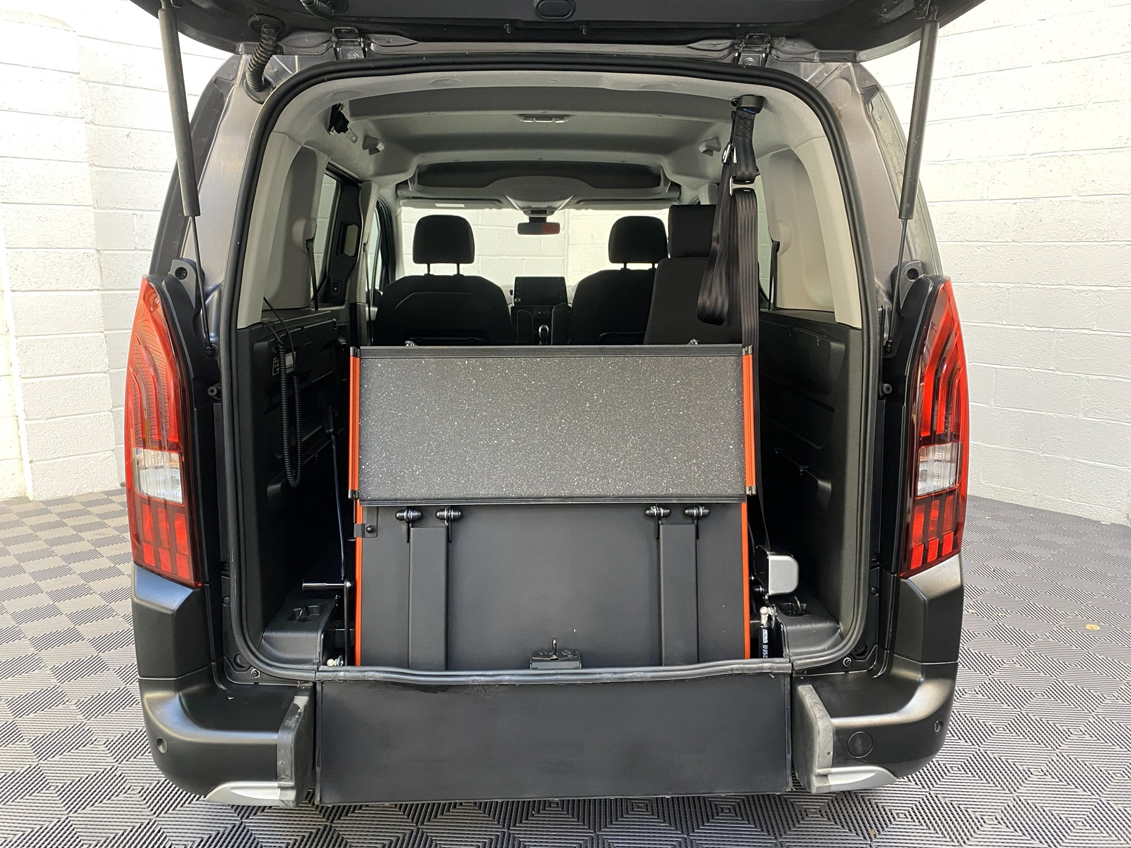 Peugeot Rifter WAV wheelchair accessible vehicle for sale at Michael Harraway Cars, Weston-super-Mare, with three passenger seats, space for one wheelchair user, and a lightweight fold-flat rear access ramp. SF20 GNP 9
