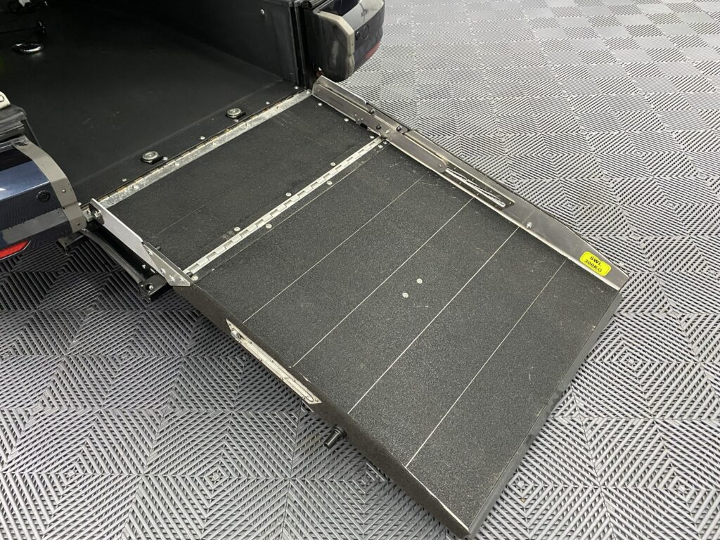 A rear wheelchair ramp fitted to a Volkswagen Caddy Maxi YY68 LHF 1