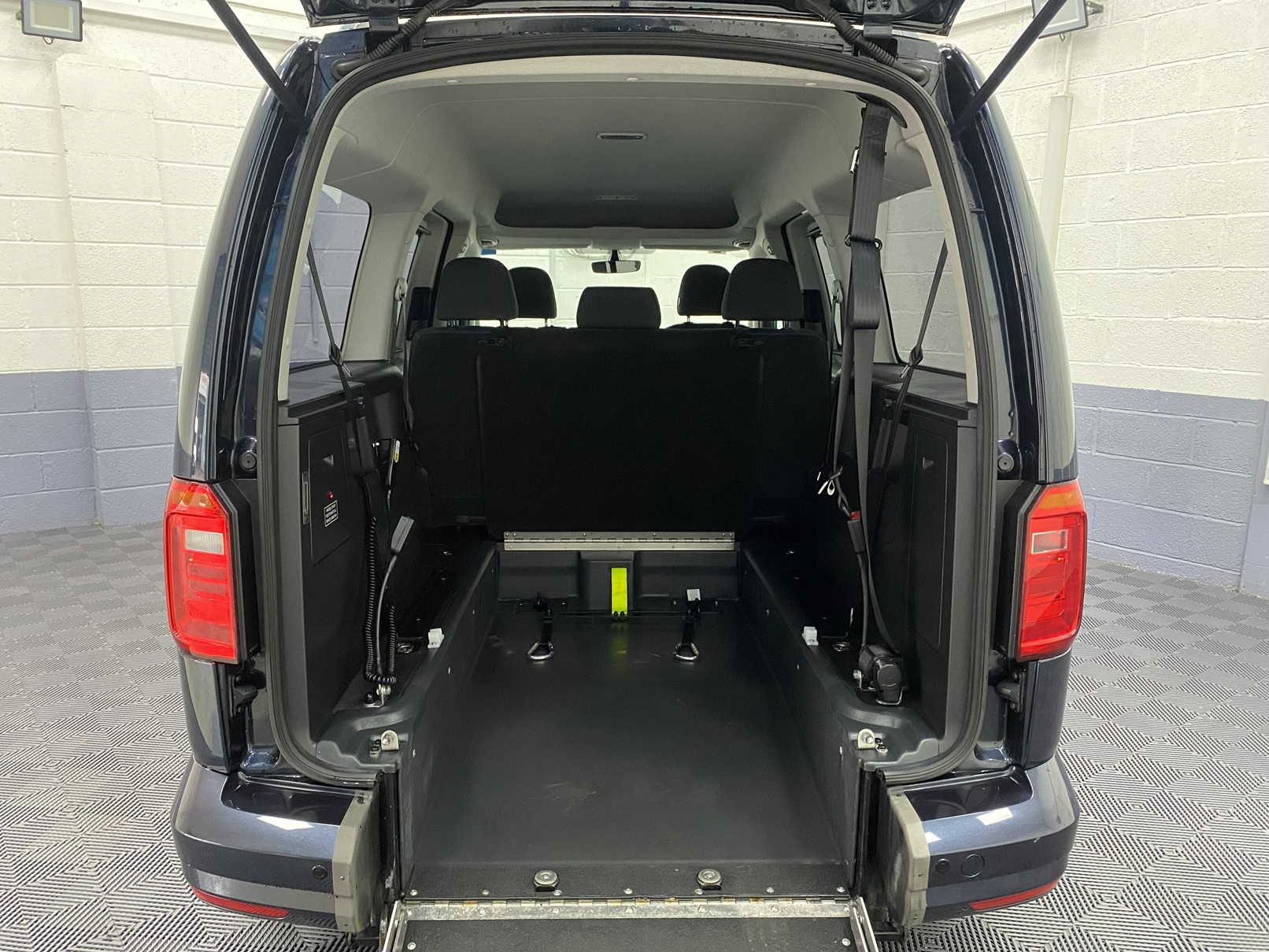 Wheelchair area in a Volkswagen Caddy Maxi WAV vehicle looking from the rear of the vehicle. YY68 LHF 1