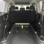 Wheelchair area in a Volkswagen Caddy Maxi WAV vehicle looking from the rear of the vehicle. Close up of wheelchair winch YY68 LHF 1