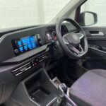 New shape Volkswagen Caddy Maxi in metallic Red that has been adapted to carry a wheelchair passenger. ND72 HOJ 10