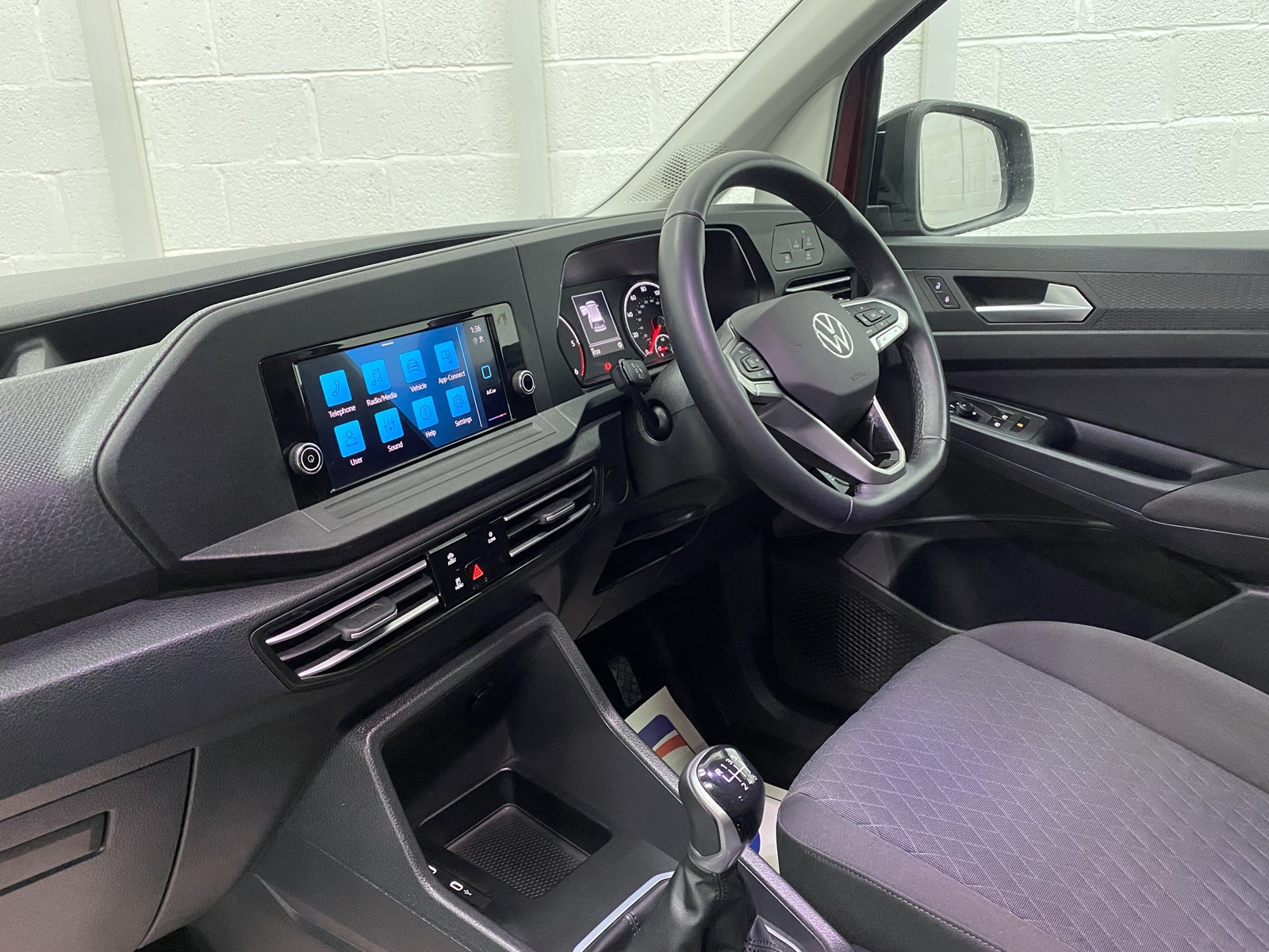 New shape Volkswagen Caddy Maxi in metallic Red that has been adapted to carry a wheelchair passenger. ND72 HOJ 10