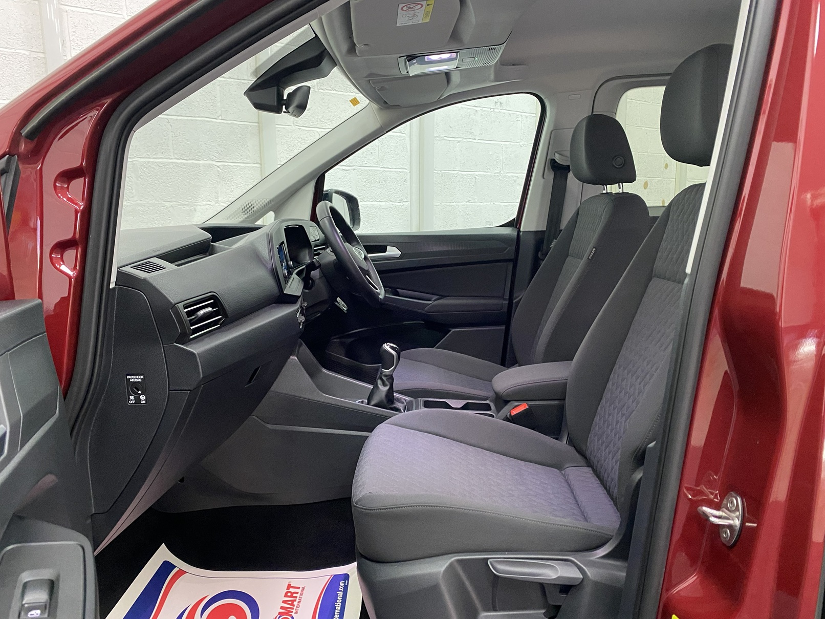 New shape Volkswagen Caddy Maxi in metallic Red that has been adapted to carry a wheelchair passenger. ND72 HOJ 12