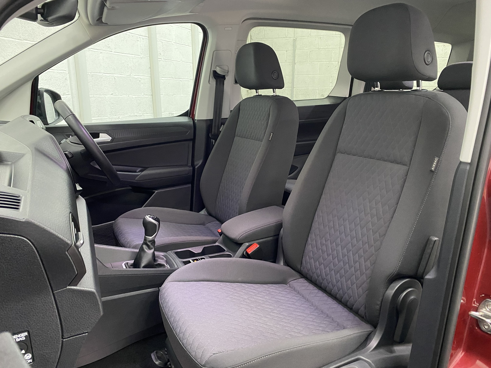 New shape Volkswagen Caddy Maxi in metallic Red that has been adapted to carry a wheelchair passenger. ND72 HOJ 14