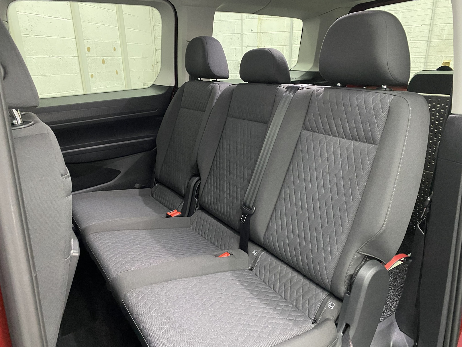 New shape Volkswagen Caddy Maxi in metallic Red that has been adapted to carry a wheelchair passenger. ND72 HOJ 15