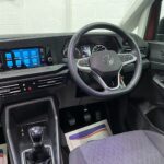 New shape Volkswagen Caddy Maxi in metallic Red that has been adapted to carry a wheelchair passenger. ND72 HOJ 16