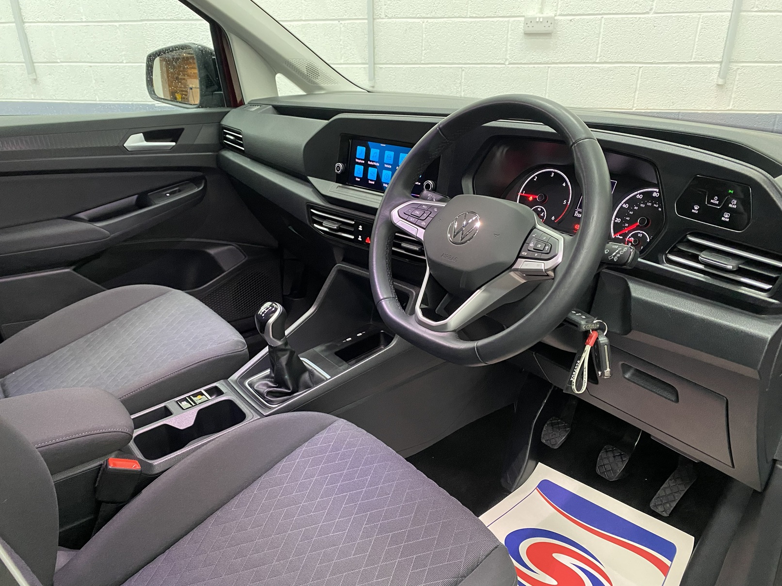 New shape Volkswagen Caddy Maxi in metallic Red that has been adapted to carry a wheelchair passenger. ND72 HOJ 17