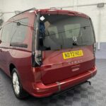 New shape Volkswagen Caddy Maxi in metallic Red that has been adapted to carry a wheelchair passenger. ND72 HOJ 2