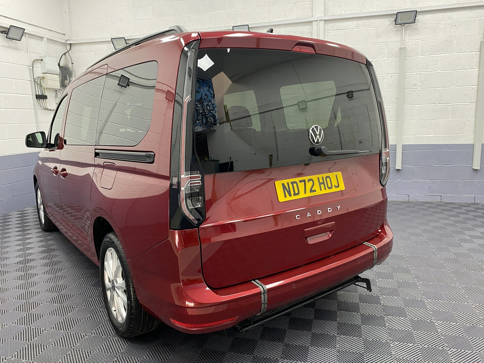 New shape Volkswagen Caddy Maxi in metallic Red that has been adapted to carry a wheelchair passenger. ND72 HOJ 2