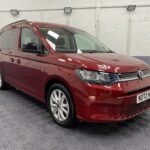 New shape Volkswagen Caddy Maxi in metallic Red that has been adapted to carry a wheelchair passenger. ND72 HOJ 27