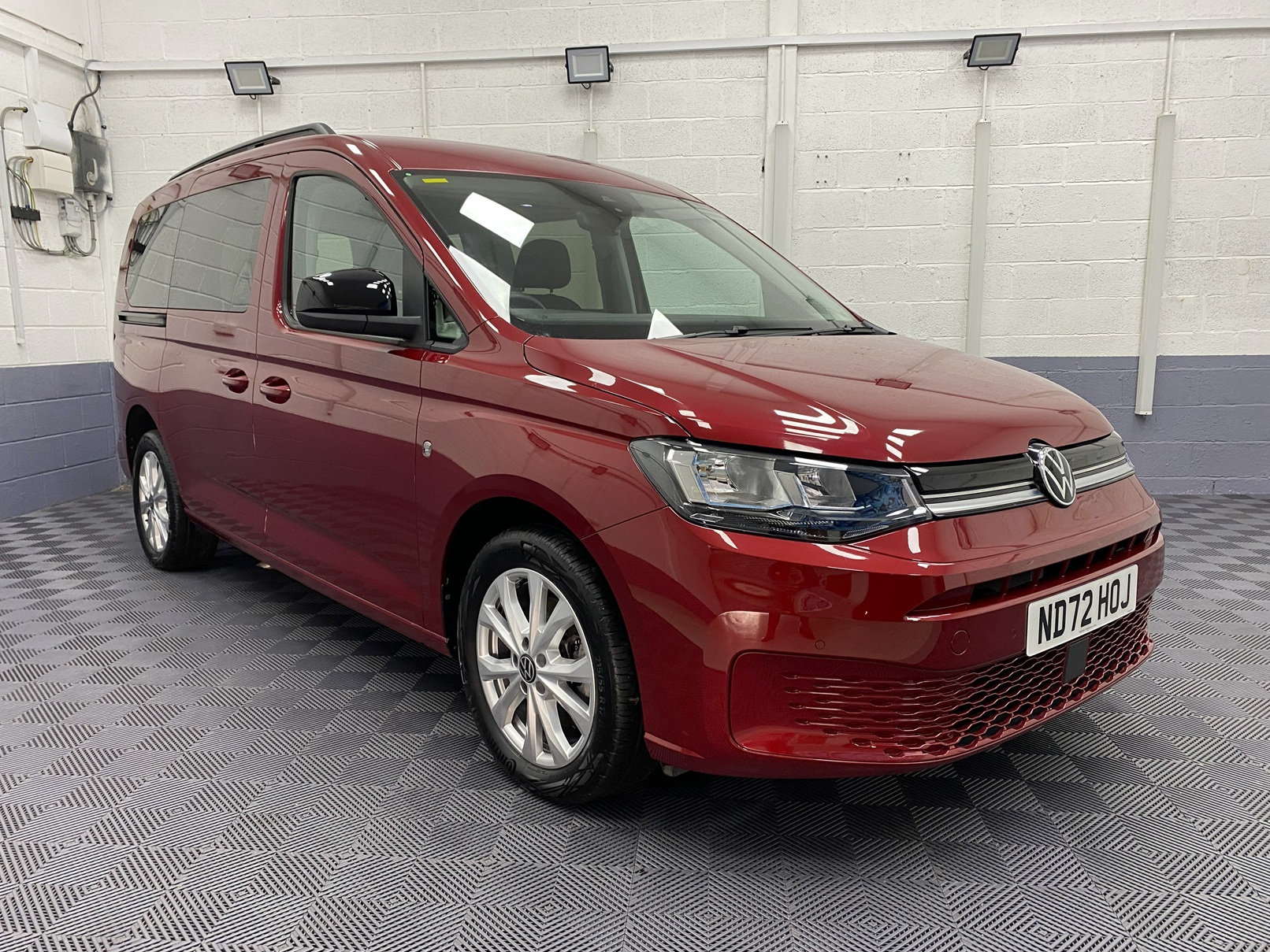 New shape Volkswagen Caddy Maxi in metallic Red that has been adapted to carry a wheelchair passenger. ND72 HOJ 27