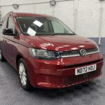 New shape Volkswagen Caddy Maxi in metallic Red that has been adapted to carry a wheelchair passenger. ND72 HOJ 28