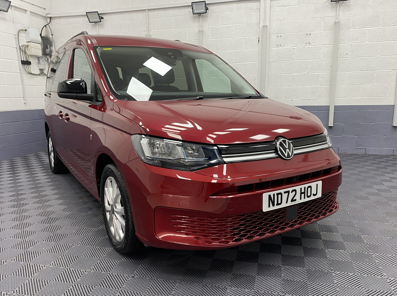 New shape Volkswagen Caddy Maxi in metallic Red that has been adapted to carry a wheelchair passenger. ND72 HOJ 28
