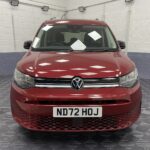 New shape Volkswagen Caddy Maxi in metallic Red that has been adapted to carry a wheelchair passenger. ND72 HOJ 29