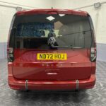 New shape Volkswagen Caddy Maxi in metallic Red that has been adapted to carry a wheelchair passenger. ND72 HOJ 3