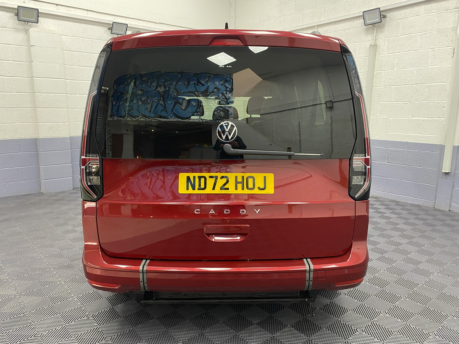 New shape Volkswagen Caddy Maxi in metallic Red that has been adapted to carry a wheelchair passenger. ND72 HOJ 3
