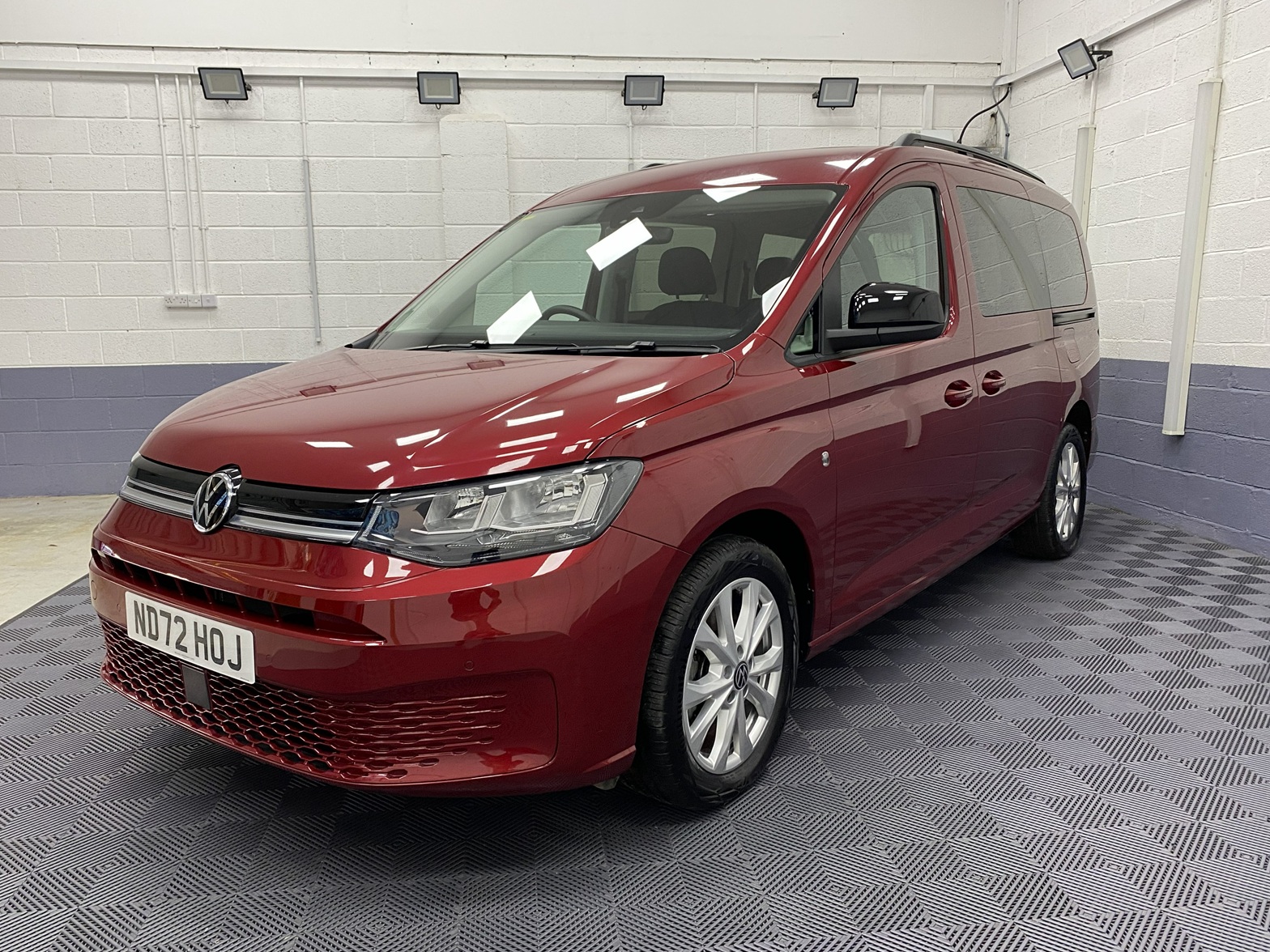 New shape Volkswagen Caddy Maxi in metallic Red that has been adapted to carry a wheelchair passenger. ND72 HOJ 30