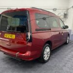 New shape Volkswagen Caddy Maxi in metallic Red that has been adapted to carry a wheelchair passenger. ND72 HOJ 4