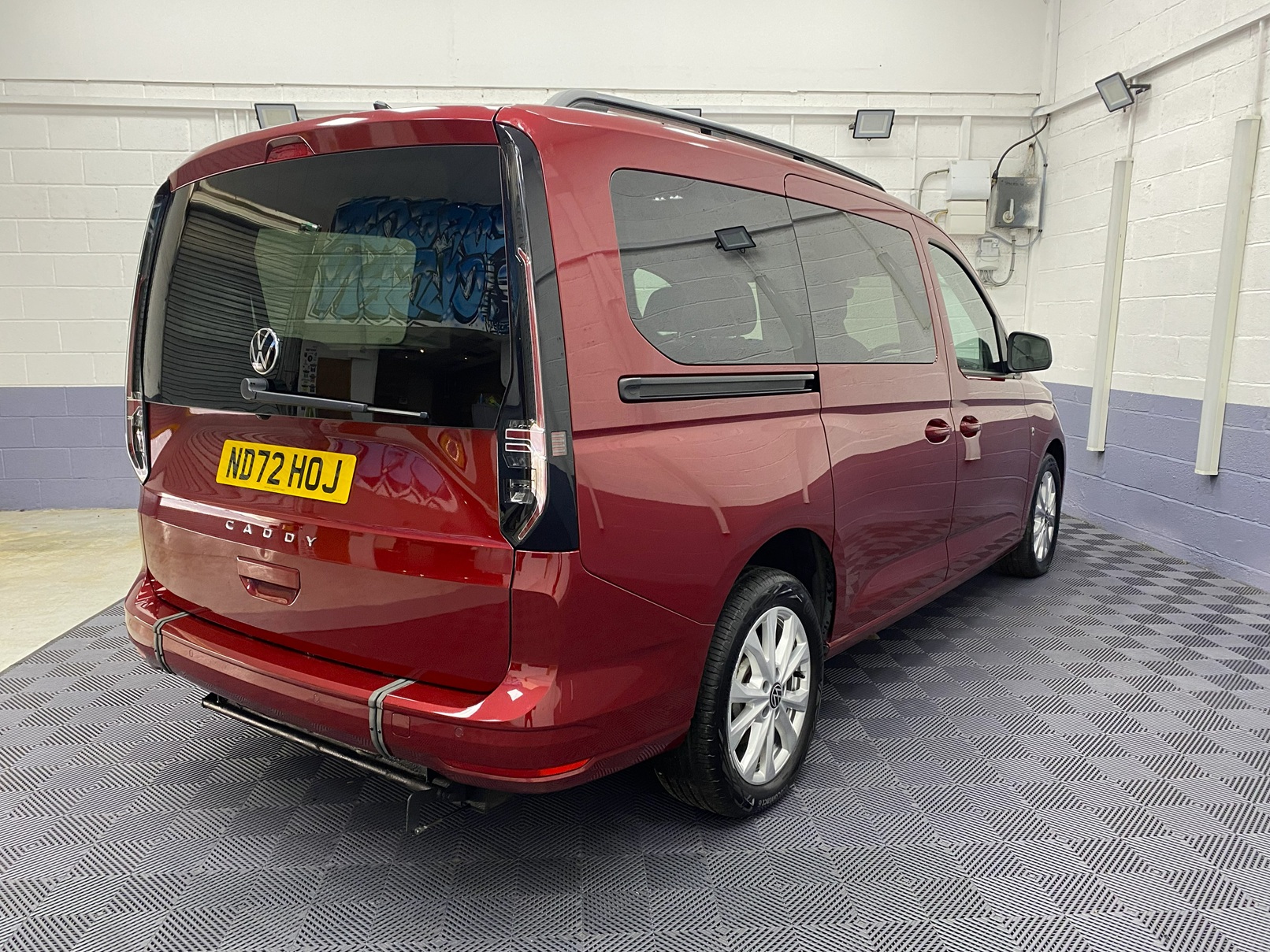 New shape Volkswagen Caddy Maxi in metallic Red that has been adapted to carry a wheelchair passenger. ND72 HOJ 4