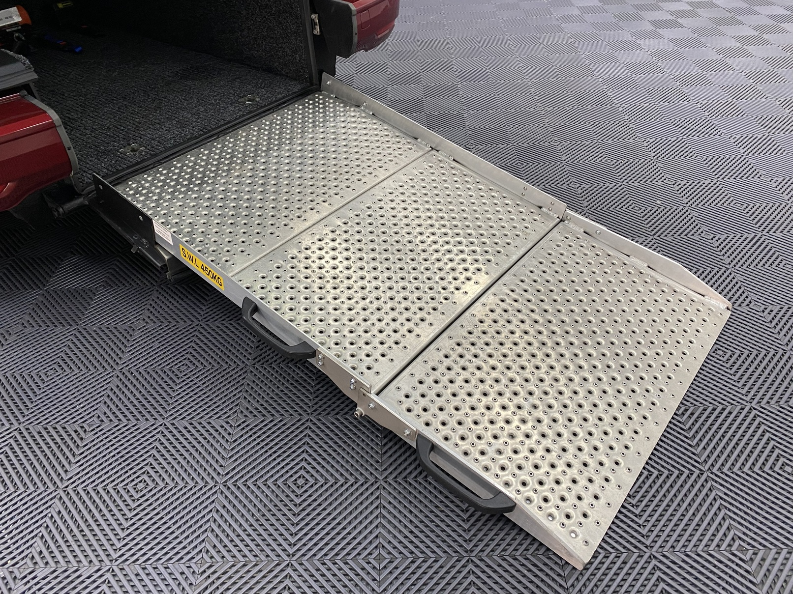 New shape Volkswagen Caddy Maxi in metallic Red that has been adapted to carry a wheelchair passenger. ND72 HOJ 55