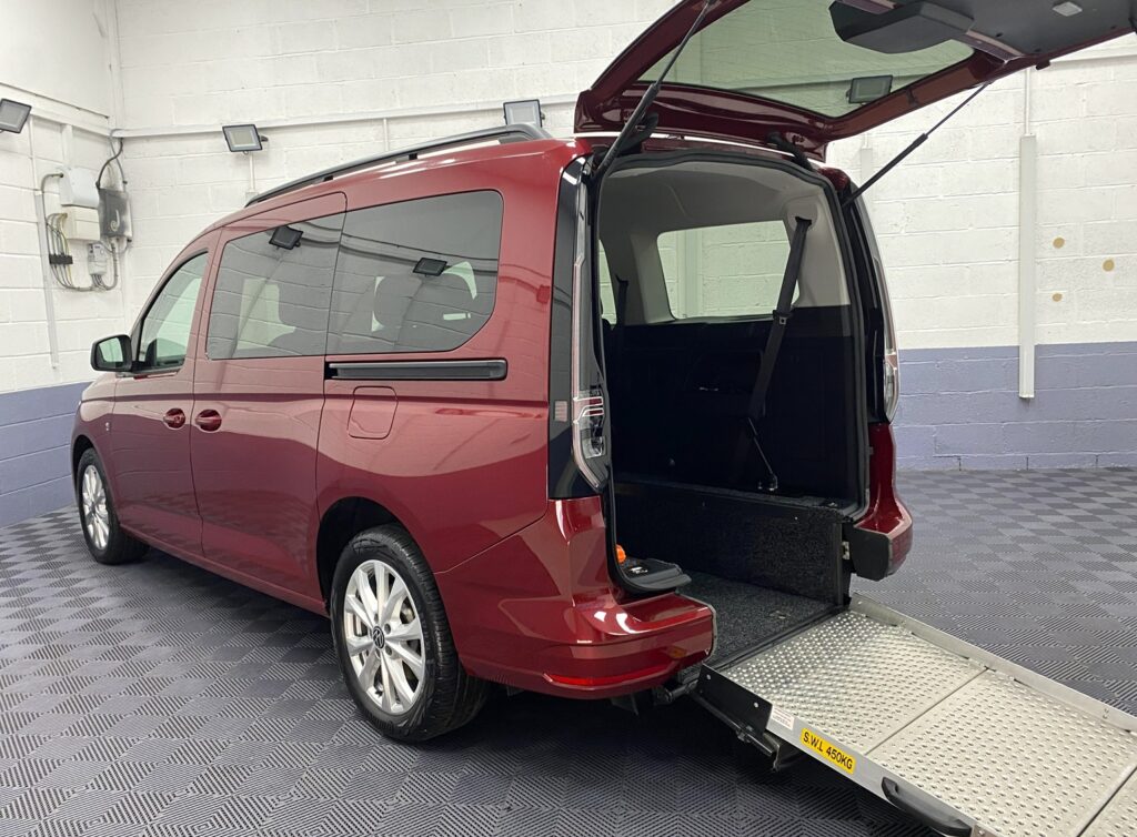 New shape Volkswagen Caddy Maxi in metallic Red that has been adapted to carry a wheelchair passenger. ND72 HOJ 6
