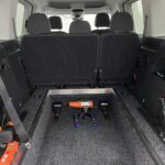 New shape Volkswagen Caddy Maxi in metallic Red that has been adapted to carry a wheelchair passenger. ND72 HOJ 8