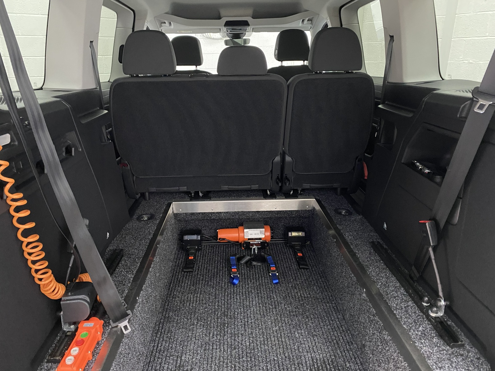 New shape Volkswagen Caddy Maxi in metallic Red that has been adapted to carry a wheelchair passenger. ND72 HOJ 8