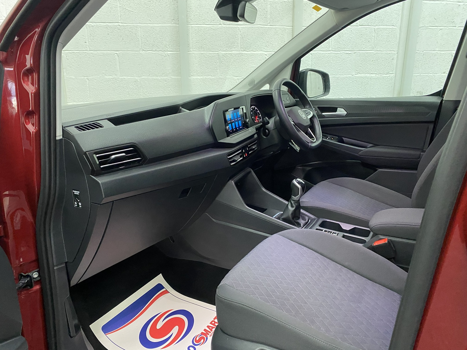 New shape Volkswagen Caddy Maxi in metallic Red that has been adapted to carry a wheelchair passenger. ND72 HOJ 9