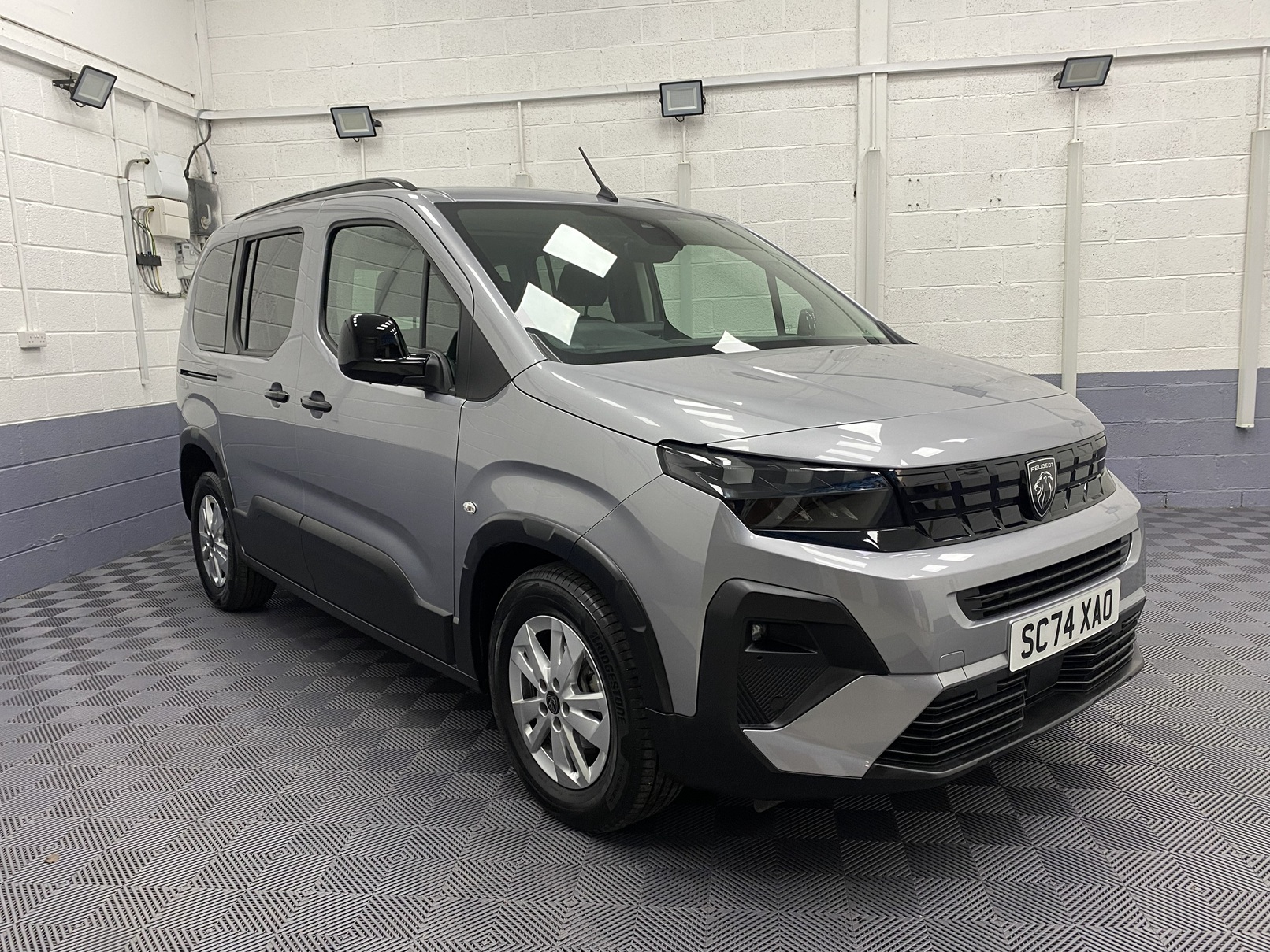 2025 grey Peugeot Rifter front three quarter view SC74 XAO