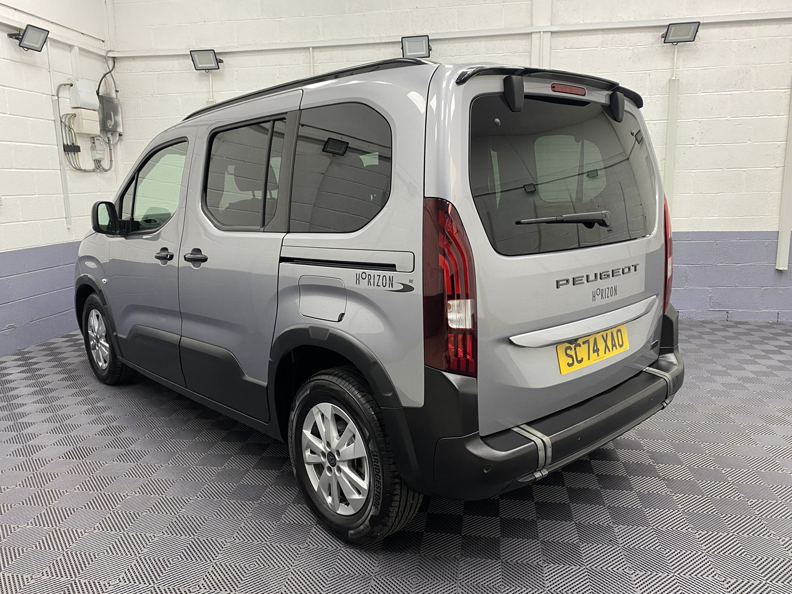 2025 grey Peugeot Rifter rear three quarter view SC74 XAO