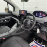 2025 Peugeot Rifter interior from drivers door view showing the steering wheel and dashboard SC74 XAO