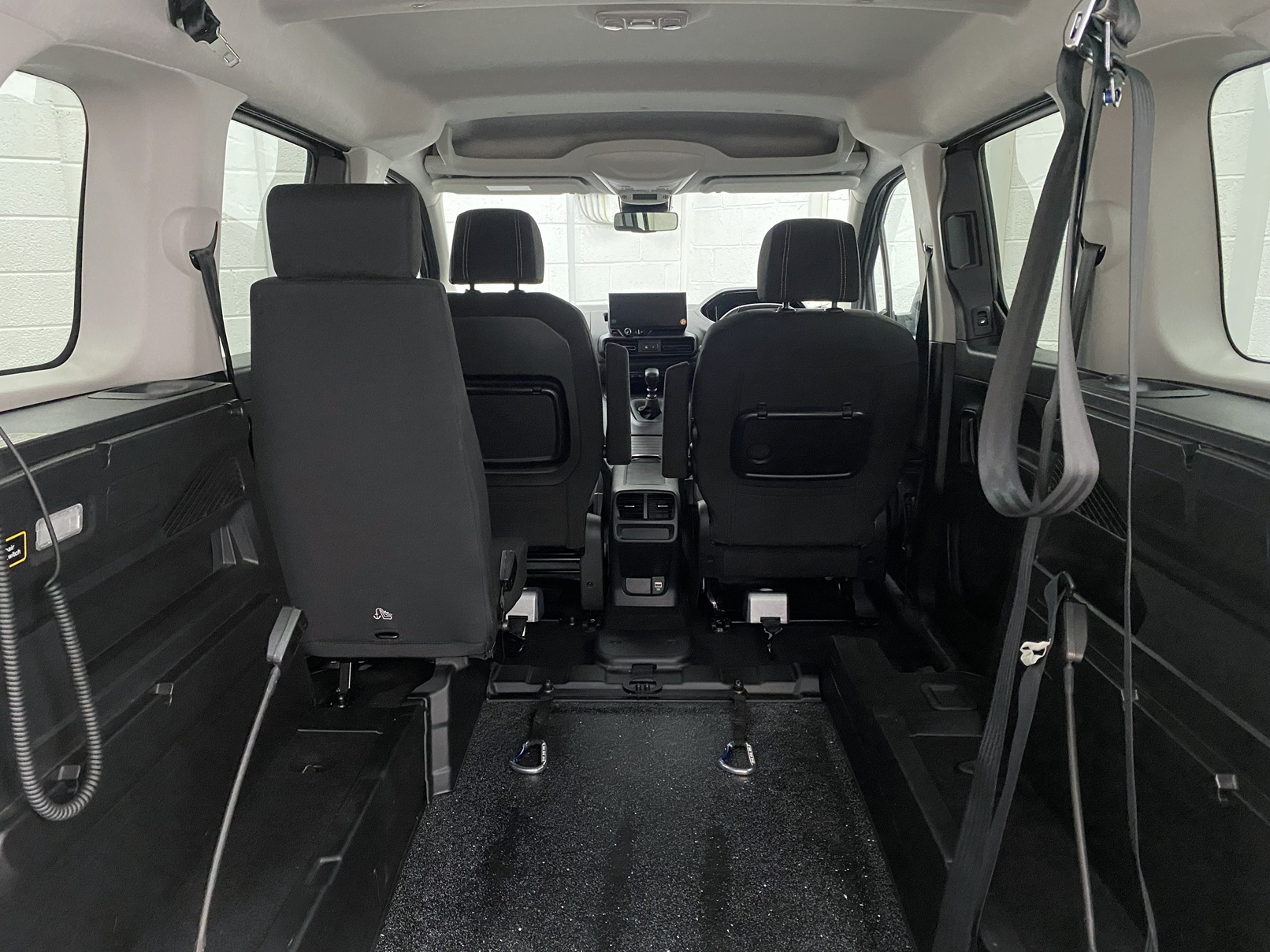 2025 Peugeot Rifter interior view of wheelchair space and single rear passenger seat SC74 XAO