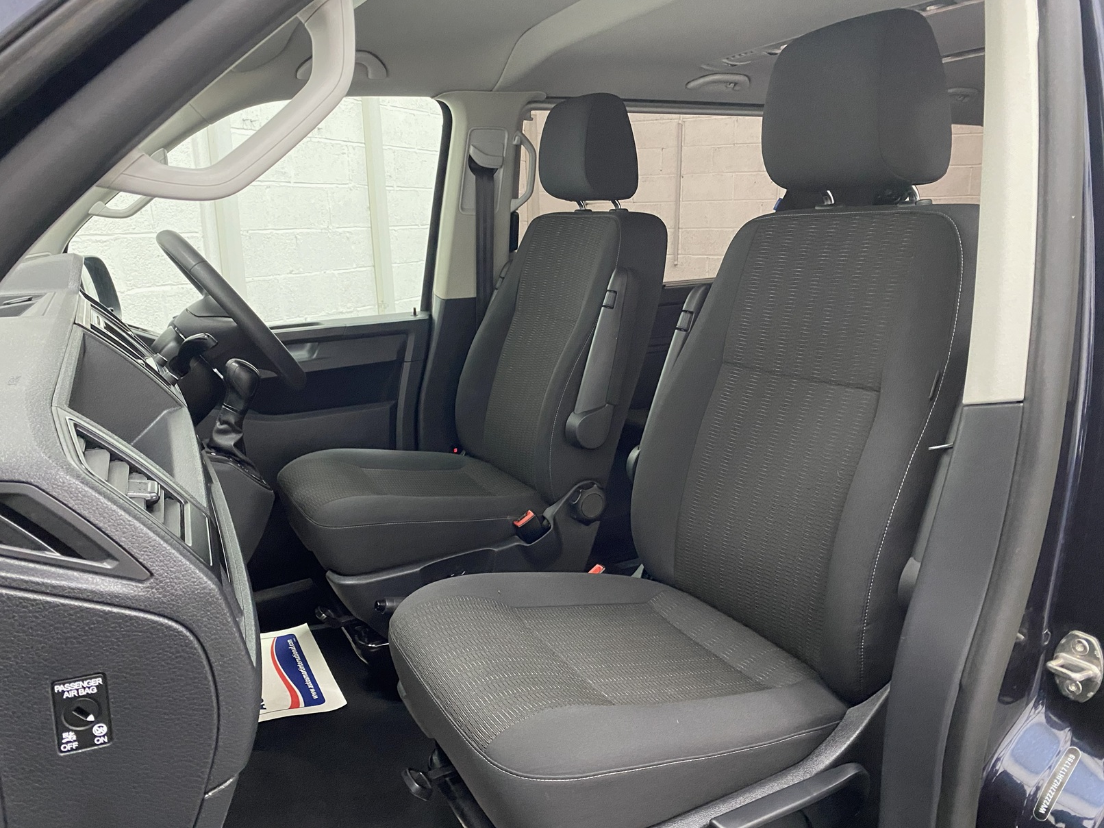 Front twin single seats in grey upholstery in a 2018 Volkswagen Transporter T6 YJ68 BMU