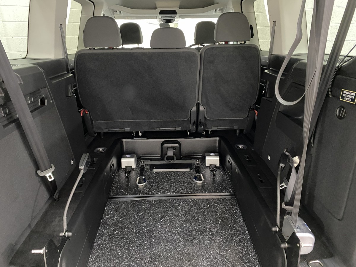 2023 Volkswagen Caddy Maxi WAV showing the rear wheelchair area and electric winch and front wheelchair restraints SJ23UDV