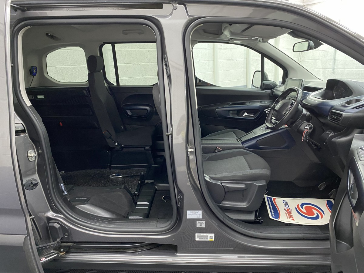 Peugeot Rifter wheelchair accessible vehicle interior view from side showing front seat and wheelchair area and single rear seat SB21GJK