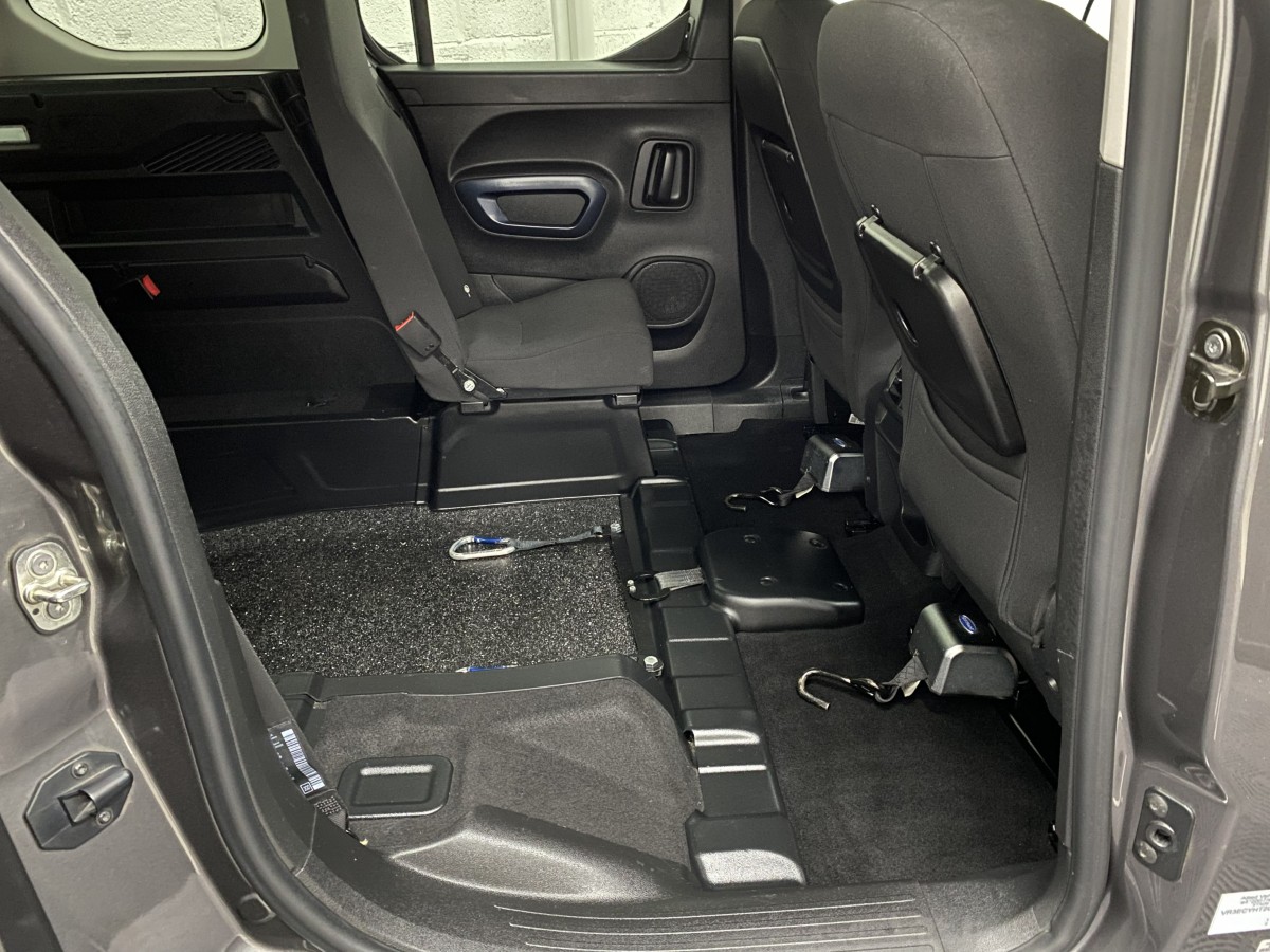 Front wheelchair restraints and electric wheelchair winch fitted to a Peugeot Rifter wheelchair accessible vehicle SB21GJF