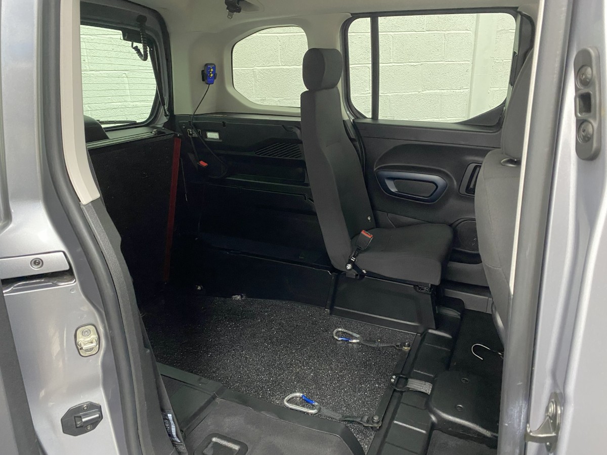 Peugeot Rifter wheelchair accessible vehicle showing wheelchair area, lowered rear floor section and single rear seat. SA22YCE