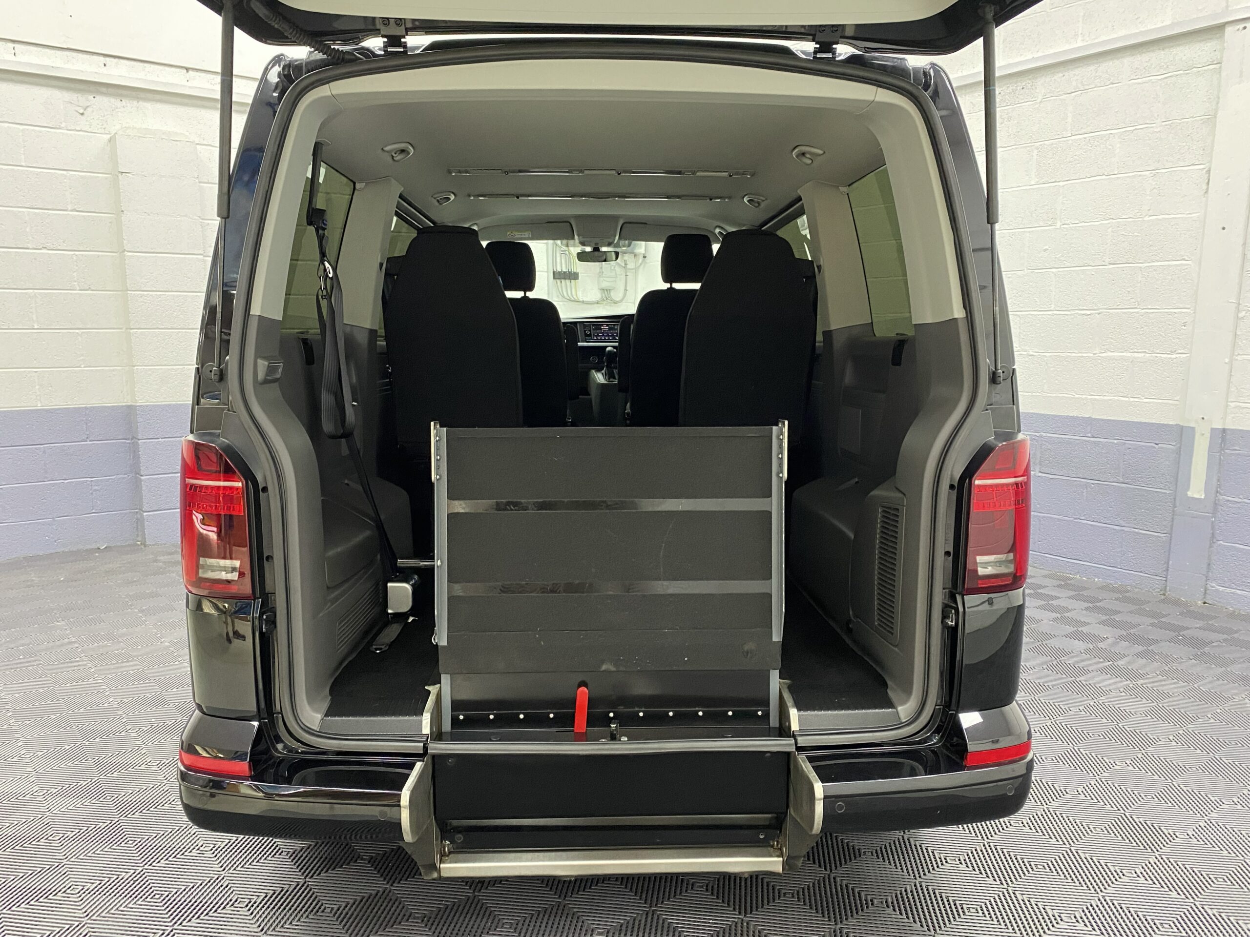 The rear wheelchair ramp in the stored position fitted to a Volkswagen Transporter T6.1 Automatic Wheelchair accessible vehicle YB21VXV
