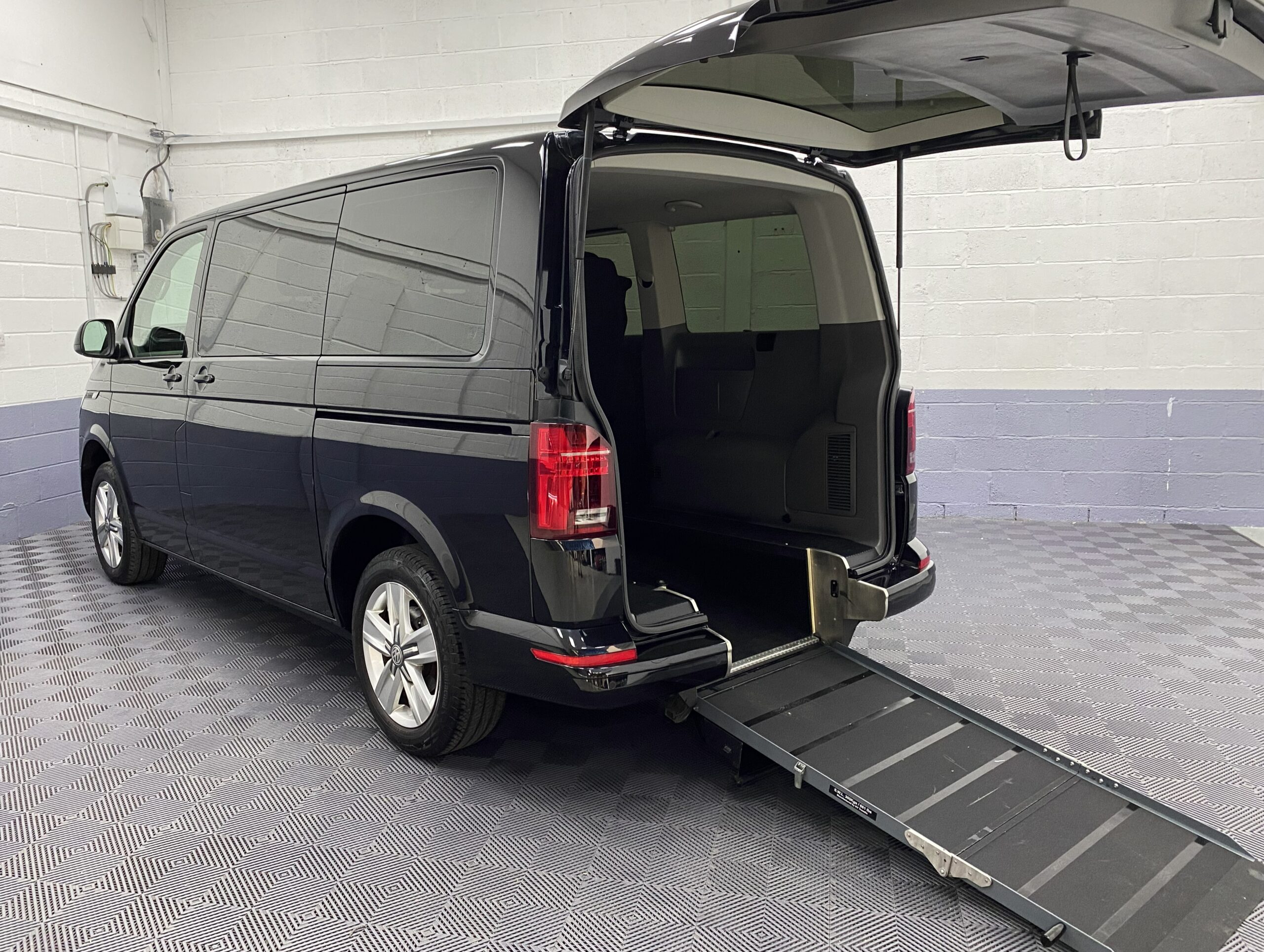 Volkswagen Transporter T6.1 Automatic Wheelchair accessible vehicle rear three quarter view with wheelchair ramp deployed YB21VXV