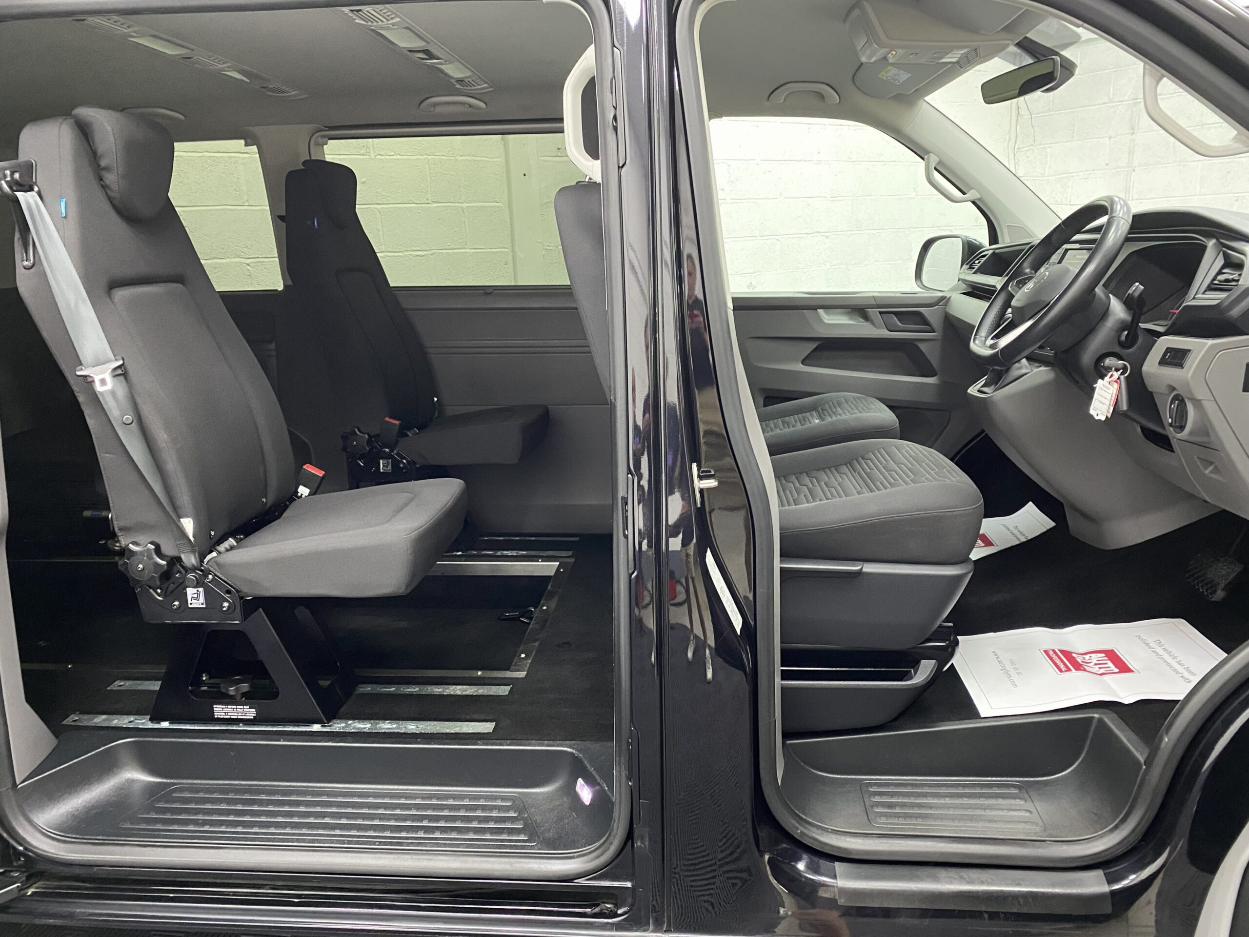 Volkswagen Transporter T6.1 Automatic Wheelchair accessible vehicle interior view from the side showing both front and rear seats YB21VXV
